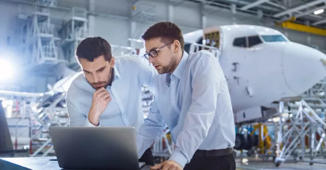 Two men working on a computer