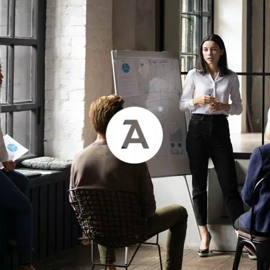 woman speaking in front of a whiteboard