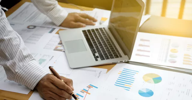testing a business continuity plan Man works with reports and laptop, RecoveryPlanner