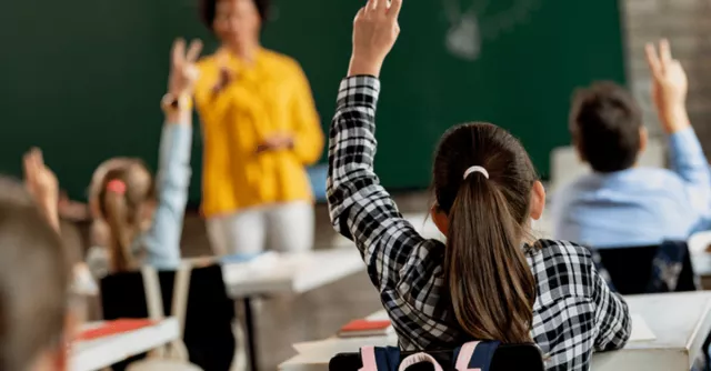 A child raises their hand