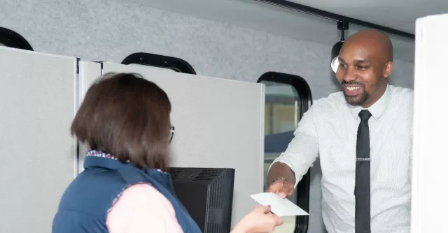 Bank teller inside mobile bank unit