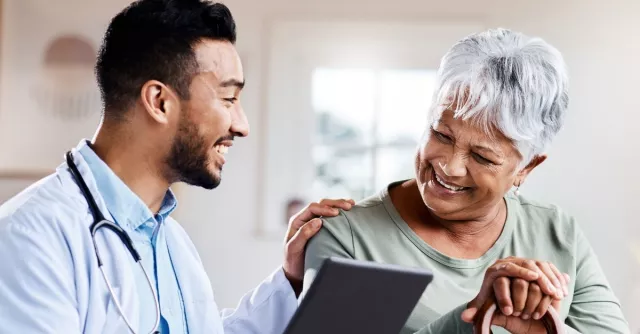 Doctor looking at ipad with patient