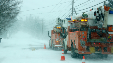 Crews repairing power lines during a snowstorm